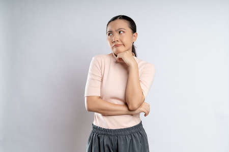 Asian woman happy confident smiling, looking at camera, standing isolated on white background.の写真素材