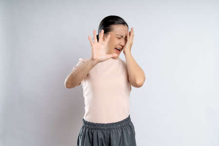 Asian woman happy confident smiling, looking at camera, standing isolated on white background.の写真素材