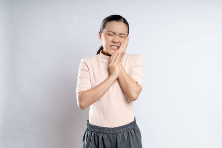 Asian woman happy confident smiling, looking at camera, standing isolated on white background.の写真素材