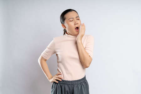 Asian woman happy confident smiling, looking at camera, standing isolated on white background.の写真素材