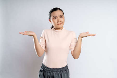 Asian woman happy confident smiling, looking at camera, standing isolated on white background.の写真素材