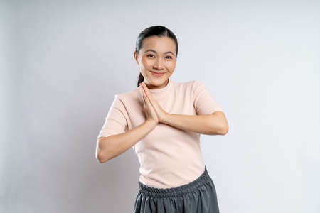 Asian woman happy confident smiling, looking at camera, standing isolated on white background.の写真素材