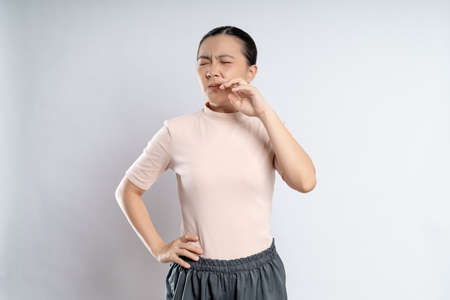 Asian woman happy confident smiling, looking at camera, standing isolated on white background.の写真素材