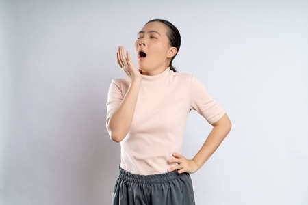Asian woman happy confident smiling, looking at camera, standing isolated on white background.の写真素材