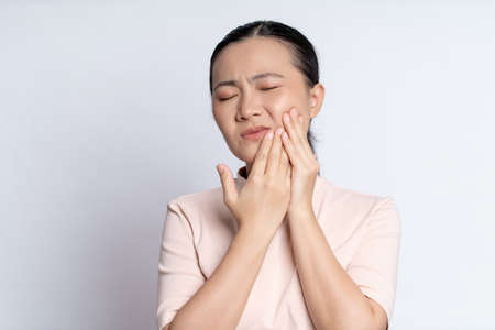 Asian woman happy confident smiling, looking at camera, standing isolated on white background.の写真素材
