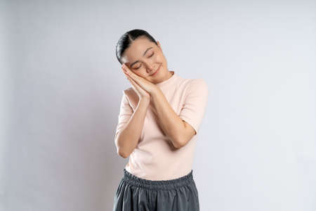 Asian woman happy confident smiling, looking at camera, standing isolated on white background.の写真素材