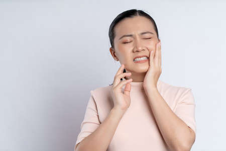 Asian woman happy confident smiling, looking at camera, standing isolated on white background.の写真素材