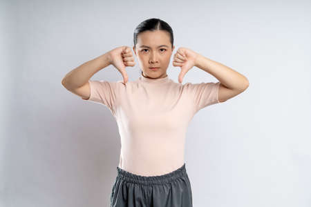 Asian woman happy confident smiling, looking at camera, standing isolated on white background.の写真素材