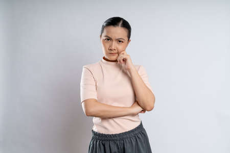 Asian woman happy confident smiling, looking at camera, standing isolated on white background.の写真素材