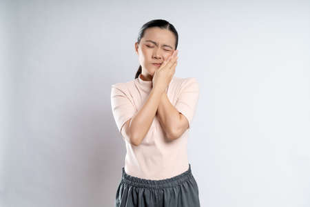Asian woman happy confident smiling, looking at camera, standing isolated on white background.の写真素材