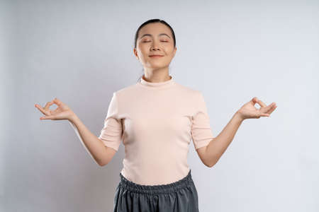 Asian woman happy confident smiling, looking at camera, standing isolated on white background.の写真素材