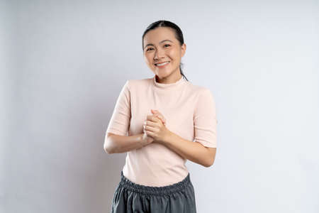Asian woman happy confident smiling, looking at camera, standing isolated on white background.の写真素材