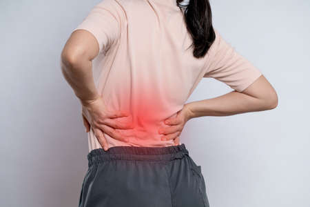 Asian woman was sick with toothache touching her cheek with red point and standing isolated on white background.の写真素材