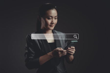 Asian woman voting and pressing angry face emoticon on virtual touch screen, isolated on background. Customer service satisfaction survey concept.の写真素材