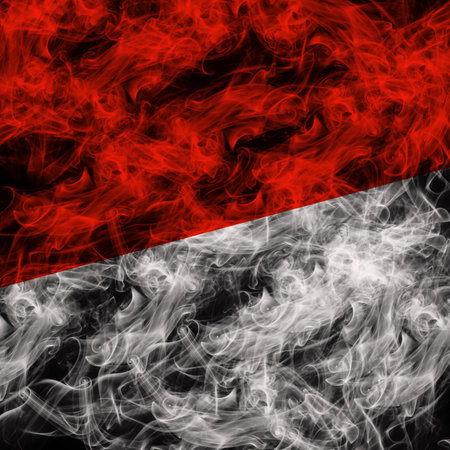 National flag of Indonesia made from colored smoke isolated on black background, abstract concept.の写真素材