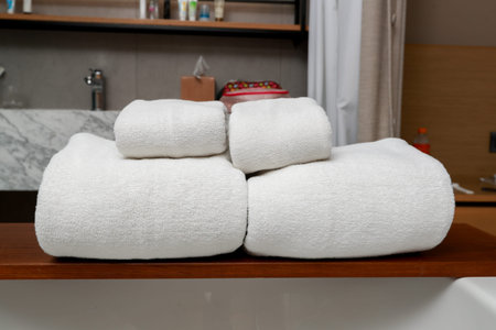 Bath towel white color put on the brown wooden inside bathroom