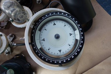 White magnetic compass of vessel had remove and lay on the floor for maintenance.