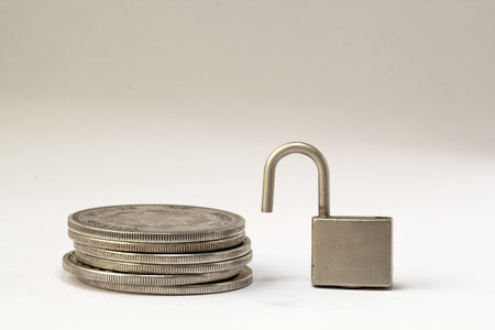 padlock and coins on the white backgroundの写真素材