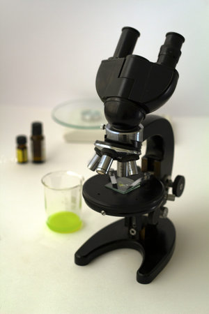 Microscope, scale and bottles in a laboratory