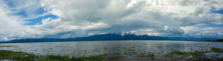 Panoramic beautiful view with the blue sky, white cloud and mountain of Kwan Phayao that is located...