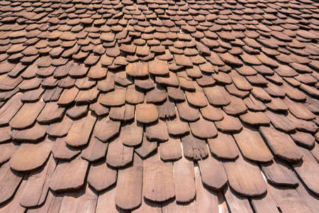 Closeup view of beautiful pattern and layer on the house's roof in the public place that is made from wooden. Warm tone.の写真素材
