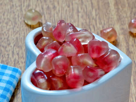 Pomegranate seeds on the hart cupの写真素材