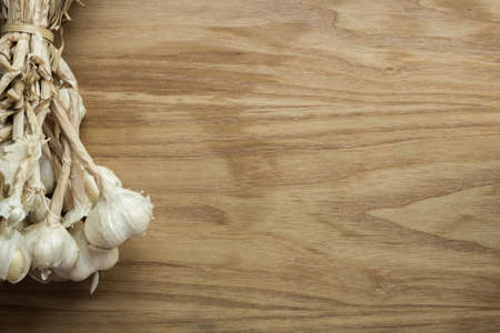 Garlic cloves on wooden vintage background.の写真素材
