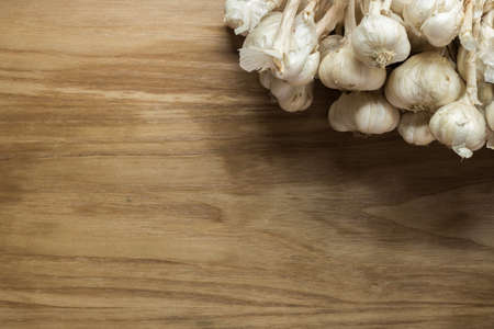 Garlic cloves on wooden vintage background.の写真素材