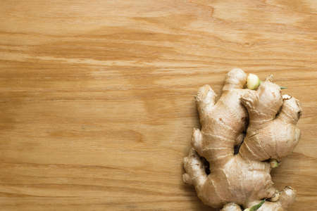 Ginger root sliced on wooden backgroundの写真素材