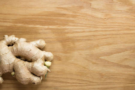 Ginger root sliced on wooden backgroundの写真素材