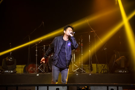 Asian singer and drummer of rock band musicians perform in concert on stageのeditorial素材