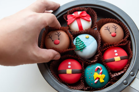 Person took the Christmas-themed cake from trays to give a special gift to a happy Christmas season, isolated on white background.の写真素材