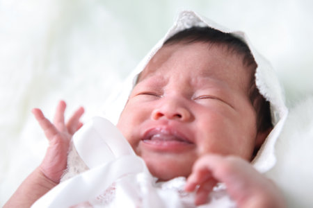 Asian beautiful newborn baby in white dress was sleeping on a white soft blanket, Infant, babyhood concept and copy space - Imageの写真素材