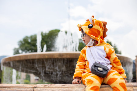 A cute Asian girl wearing a giraffe costume, Sunglasses travel in a new normal state with a face...