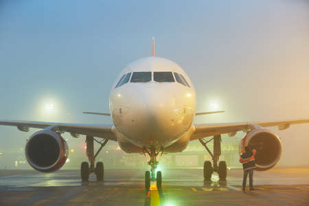 Ground staff is checking airplane before take off.の写真素材