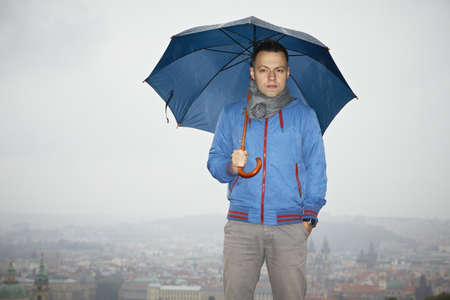 Rainy day in Prague - young man with umbrella の写真素材