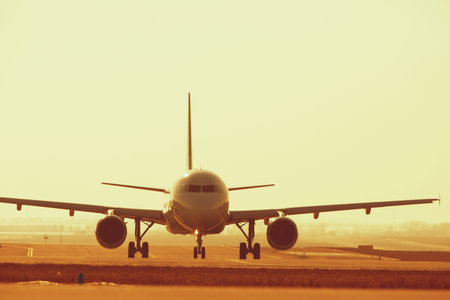 Airplane at sunset - back lit の写真素材