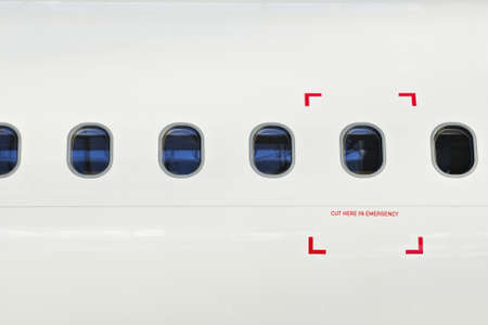 Windows of airplane with emergency sign  の写真素材