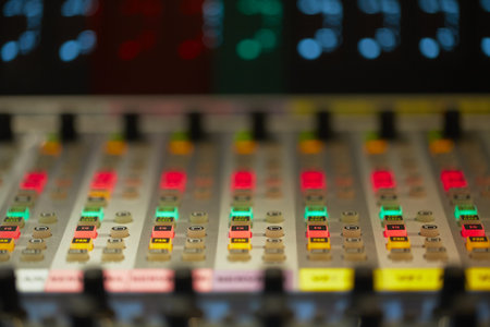 Professional audio mixing console with faders and adjusting knobs - radio / TV broadcasting