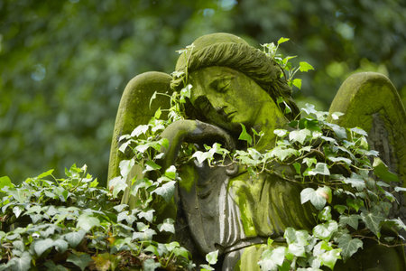Sad angel statue on old cemetery の写真素材