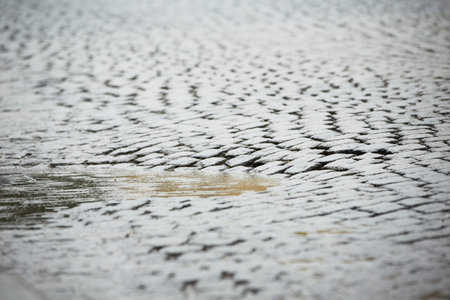 Puddle of water in rain - old roadの写真素材