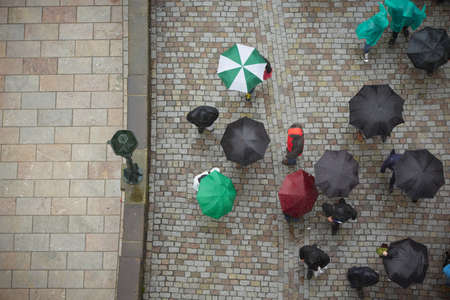 Group of people in rain - Prague, Czech Republicの写真素材