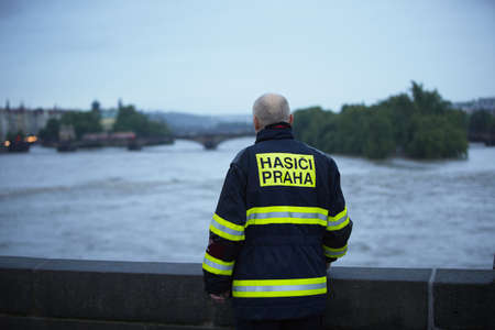 PRAGUE - JUNE 2: Fireman Vaclav Kratochvil on Charles Bridge. The Czech Capital - Prague is on high alert as a swell of floodwater moves in from the south. Charles Bridge is closed by police and firemen, they have been putting up metal flood barriers alonのeditorial素材