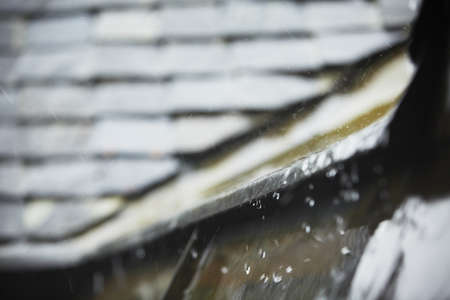 Old tiled roof in heavy rain - selective focusの写真素材