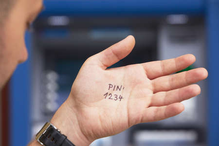Man look at the simple PIN code written on the palm の写真素材