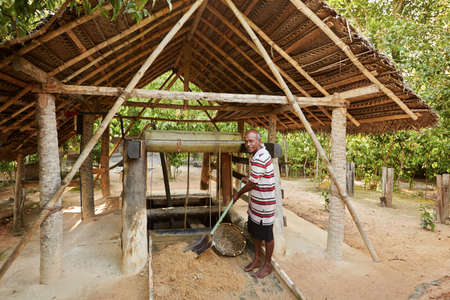 MEETIYAGODA, SRI LANKA - SEPTEMBER 9  Worker is gathering excavated materials to search gemstone in moonstone mine on September 9, 2013 in Meetiyagoda  Moonstone is one of the gems found in Sri Lanka のeditorial素材