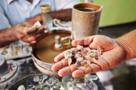 Craftsman is showing moonstone. It is one of the gems found in Sri Lanka. - Selective focus