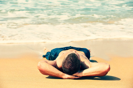 Muscular man on the beach - copy spaceの写真素材