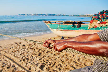 Fisherman is pulling the net out of the sea.の写真素材