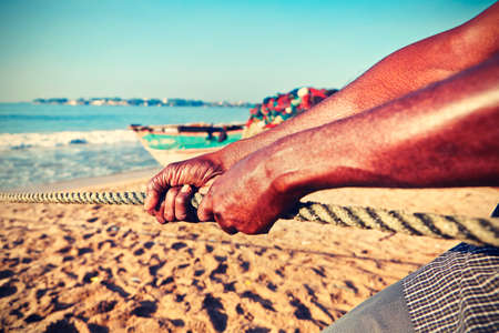 Fisherman is pulling the net out of the sea.の写真素材